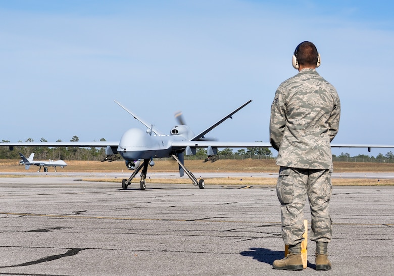 Senior Airman Frank, 49th Aircraft Maintenance Squadron crew chief, watches as an MQ-9 Reaper taxis on the flightline March 15, at Duke Field, Fla., after completing the day’s mission. This marked the second appearance ever by the unmanned aerial vehicle in the air-to-ground Weapon System Evaluation Program, Combat Hammer. (U.S. Air Force photo by Susan Garcia)