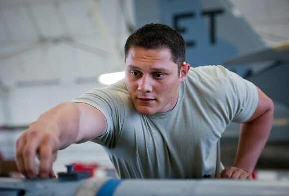 Staff Sgt. Vincent Franco, 96th Aircraft Maintenance Squadron Red team, performs checks on an AIM-120 missile prior to loading it on an F-15 Eagle March 25 at Eglin Air Force Base, Fla.  The Red team battled the Blue AMU team for weapons loadcrew supremacy during the quarterly competition.  The Red team claimed victory this quarter.  (U.S. Air Force photo/Samuel King Jr.)