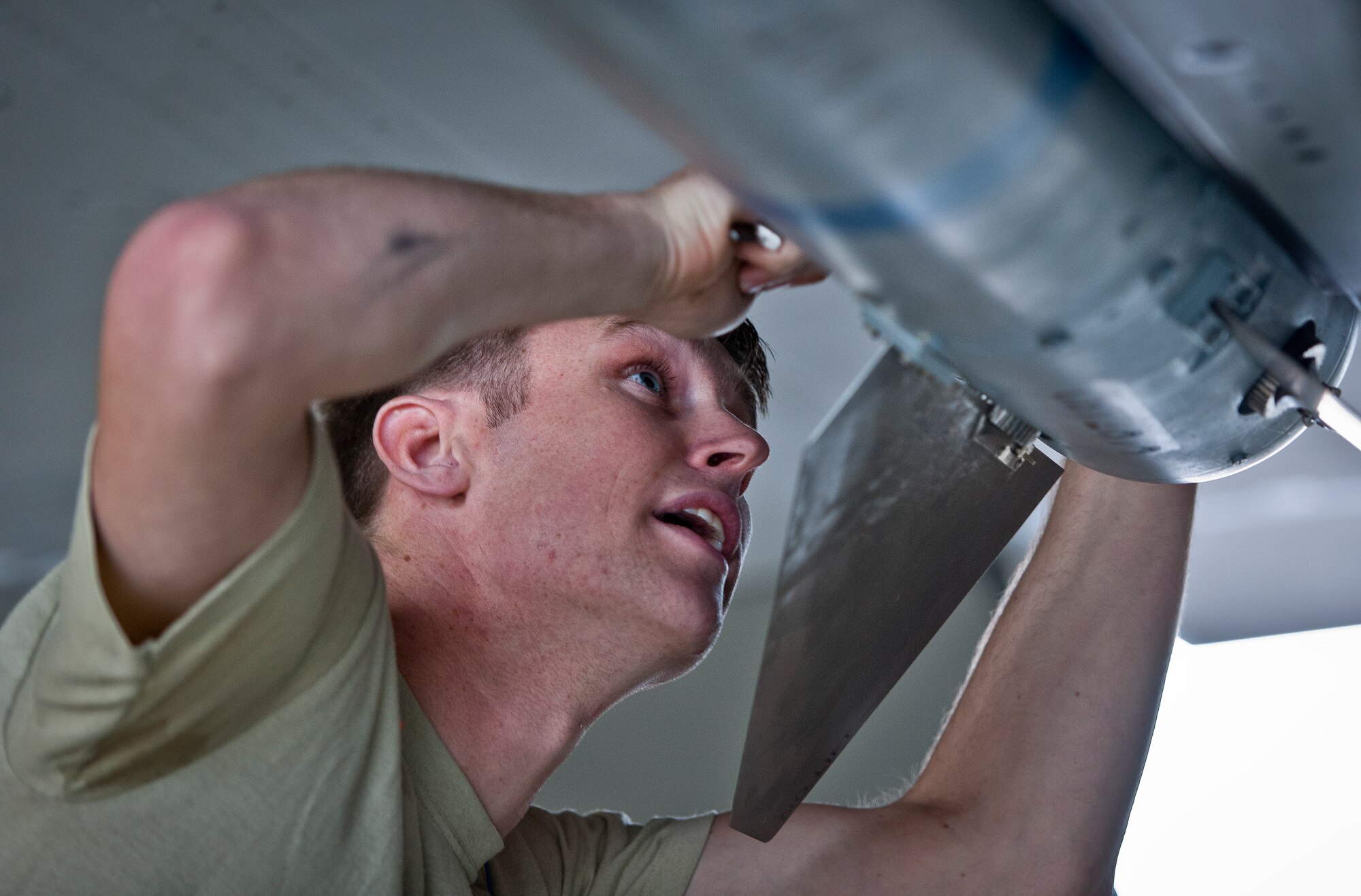 Airman 1st Class William Wakeland, 96th Aircraft Maintenance Squadron Red team, secures a fin to an AIM-120 missile on an F-15 Eagle March 25 at Eglin Air Force Base, Fla.  The Red team battled the Blue AMU team for weapons loadcrew supremacy during the quarterly competition.  The Red team claimed victory this quarter.  (U.S. Air Force photo/Samuel King Jr.)