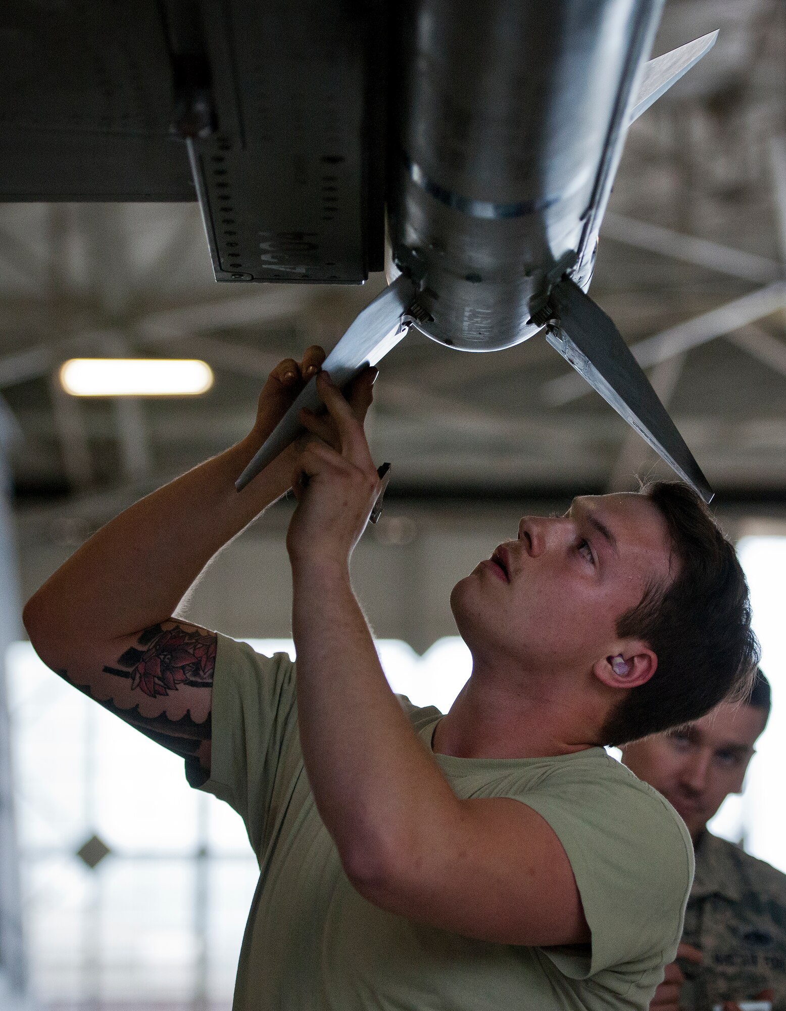 Airman 1st Class Patrick Lehmann, 96th Aircraft Maintenance Squadron Blue team, secures a fin to an AIM-120 missile on an F-16 Fighting Falcon March 25 at Eglin Air Force Base, Fla.  The Blue team battled the Red AMU team for weapons loadcrew supremacy during the quarterly competition.  The Red team claimed victory this quarter.  (U.S. Air Force photo/Samuel King Jr.)
