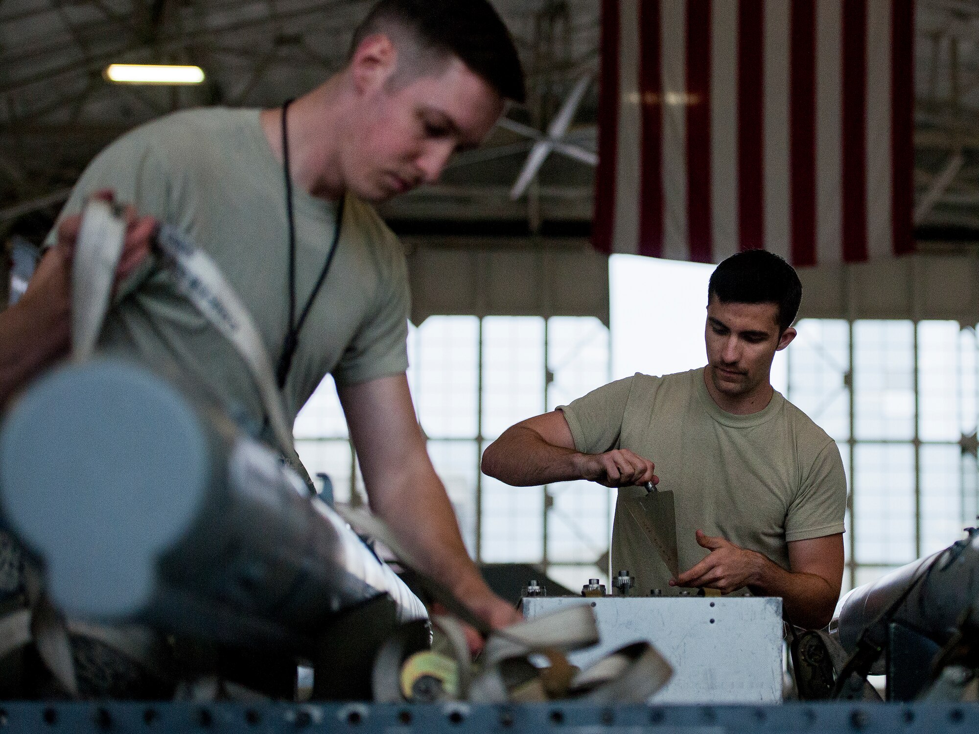 Members of the 96th Aircraft Maintenance Squadron Blue team perform checks on an AIM-120 missile they will be loading onto an F-16 Fighting Falcon March 25 at Eglin Air Force Base, Fla.  The Blue team battled the Red AMU team for weapons loadcrew supremacy during the quarterly competition.  The Red team claimed victory this quarter.  (U.S. Air Force photo/Samuel King Jr.)