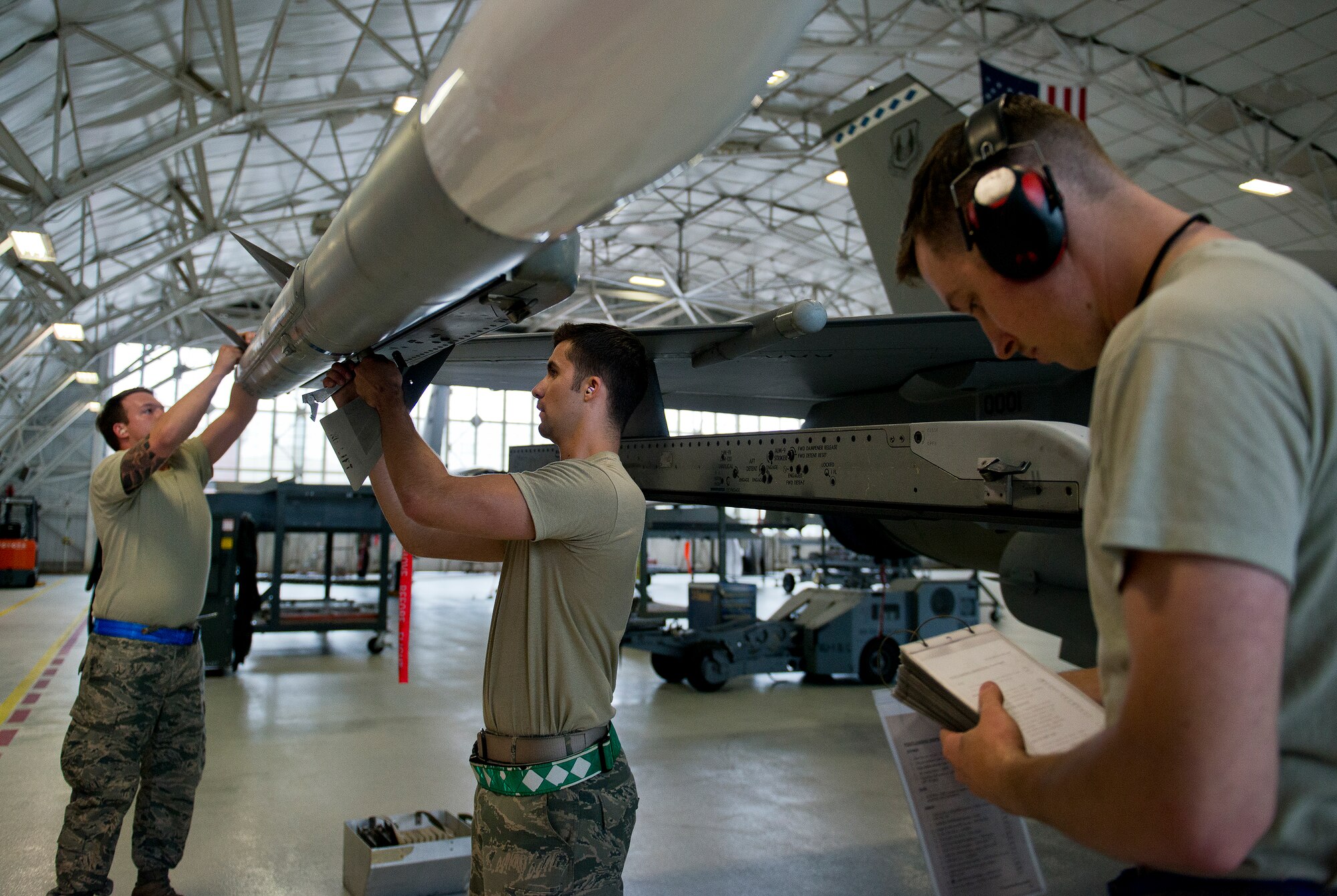 The 96th Aircraft Maintenance Squadron Blue team secure fins to an AIM-120 missile and complete an F-16 Fighting Falcon checklist March 25 at Eglin Air Force Base, Fla.  The Blue team battled the Red AMU team for weapons loadcrew supremacy during the quarterly competition.  The Red team claimed victory this quarter.  (U.S. Air Force photo/Samuel King Jr.)