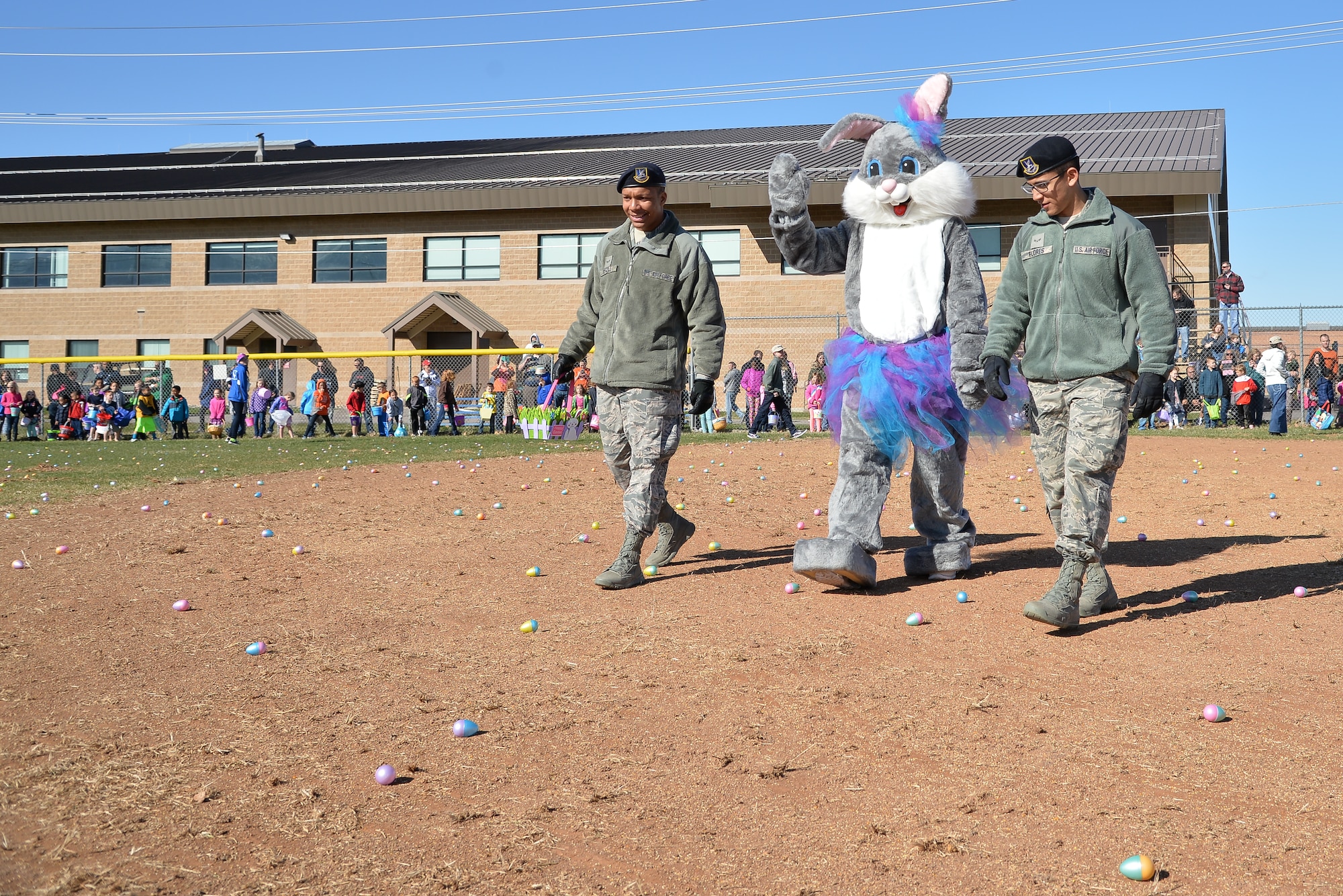 The Easter Bunny is escorted by 75th Security Forces Squadron members Airman 1st Class Alexander Settle, left, and Airman 1st Class Austin Flores, March 26 during an Easter egg hunt at Hill Air Force Base, Utah. (U.S. Air Force photo by R. Nial Bradshaw)