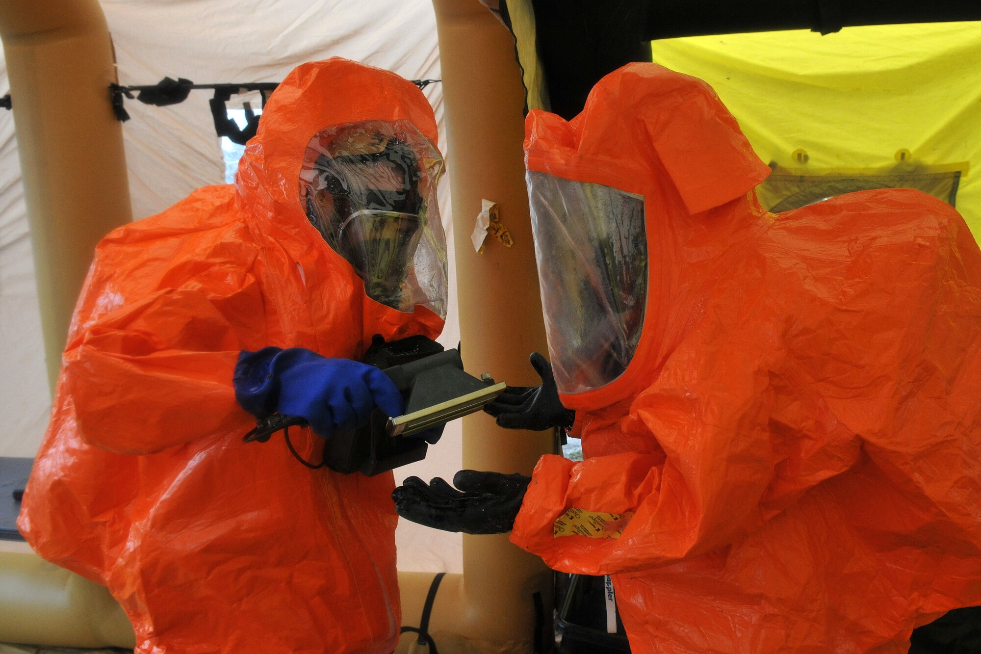 Members of the 52nd Civil Support Team, Ohio National Guard, make their way through the decontamination tent taking necessary steps to ensure their overall safety after exiting the downtown Toledo, Ohio School March 10, 2016. The training exercise was designed to enhance familiarization of equipment and build partnership with civil and military organizations to strengthen real-world emergency response capabilities. (Air National Guard photo by Airman 1st Class Benjamin A. Maciejewski)