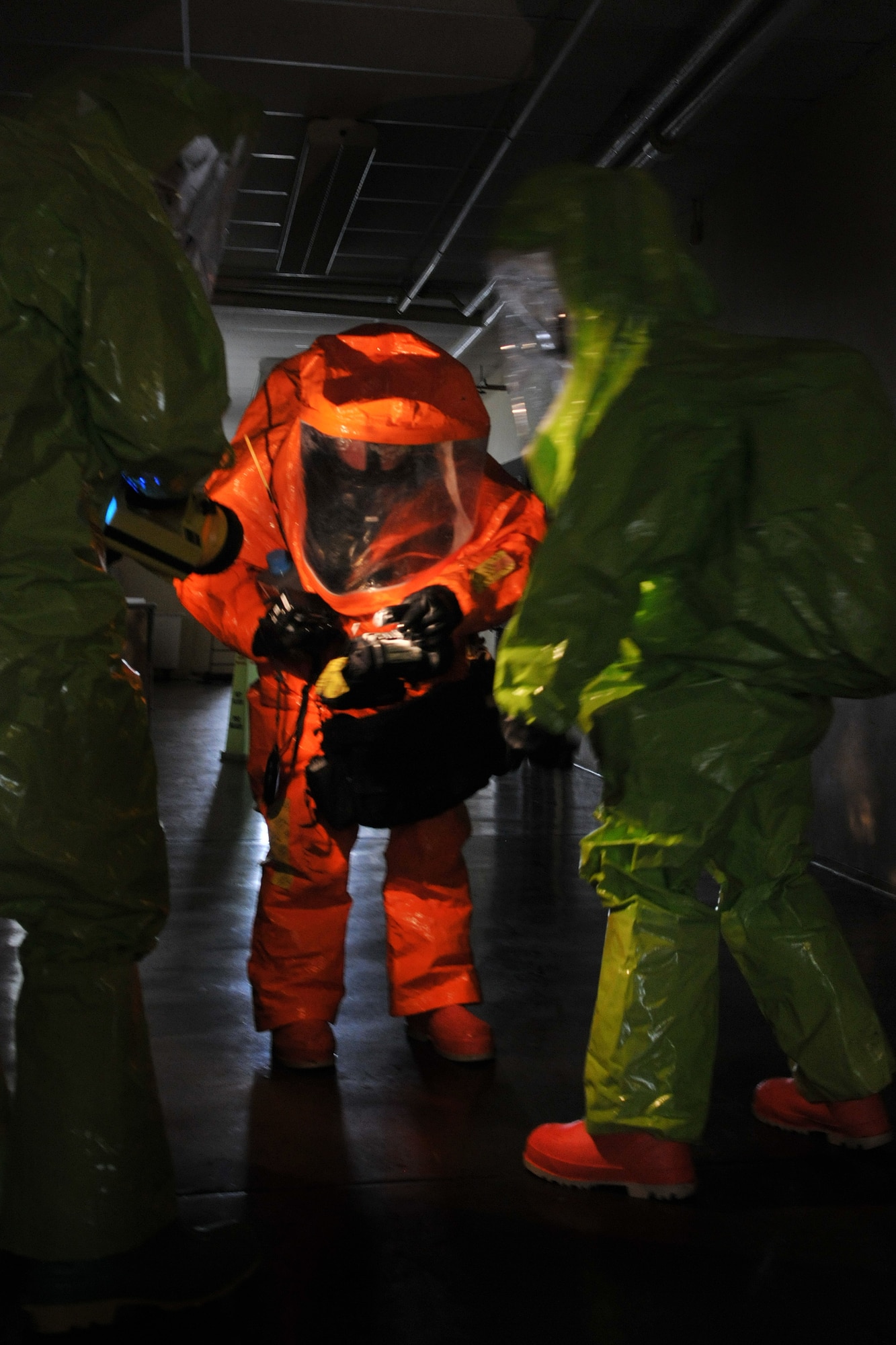 Members of the 180th Fighter Wing Ohio Air National Guard and 127th Wing Michigan National Guard prepare themselves by gathering the instruments necessary before making entry into a simulated hazmat lab in an abandoned downtown Toledo school March 10, 2016. The training exercise was designed to enhance familiarization of equipment and build partnership with civil and military organizations to strengthen real-world emergency response capabilities. (Air National Guard photo by Airman 1st Class Benjamin A. Maciejewski)