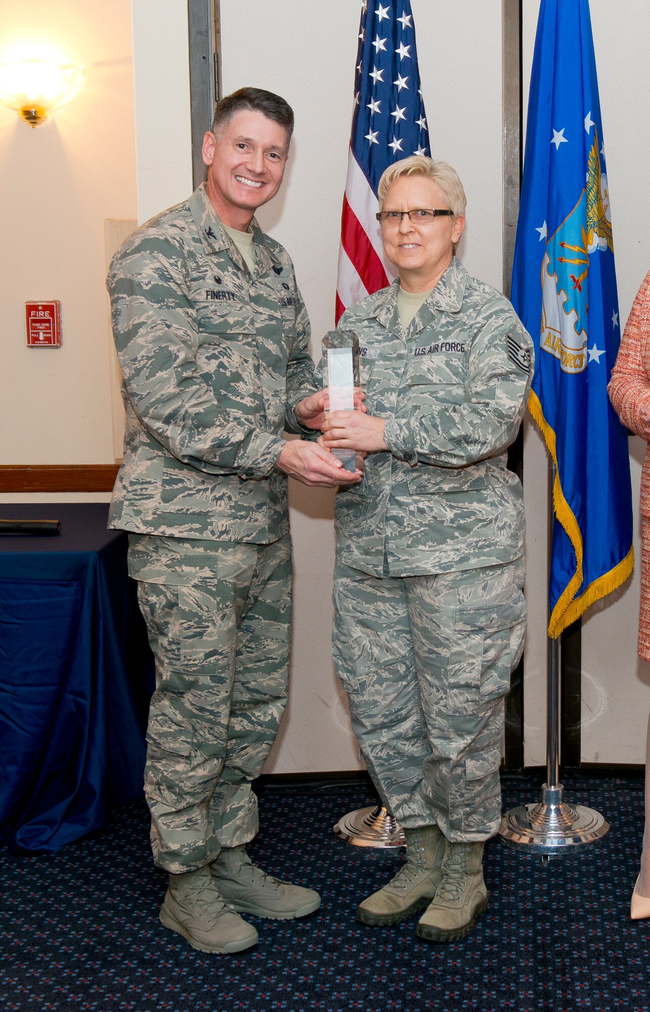 Col. Christopher E. Finerty, the vice commander of the Air National Guard Readiness Center Joint Base Andrews, Md., presents the Non-Commissioned Officer of the Year award to Technical Sgt. Vicki J Stearns during the 2015 ANGRC annual awards ceremony, April 18, 2016. The ceremony recognizes significant contributions in leadership, job performance in their primary duties, self-improvement, and base and community involvement. (Air National Guard photo by Master Sgt. Marvin R. Preston/Released)