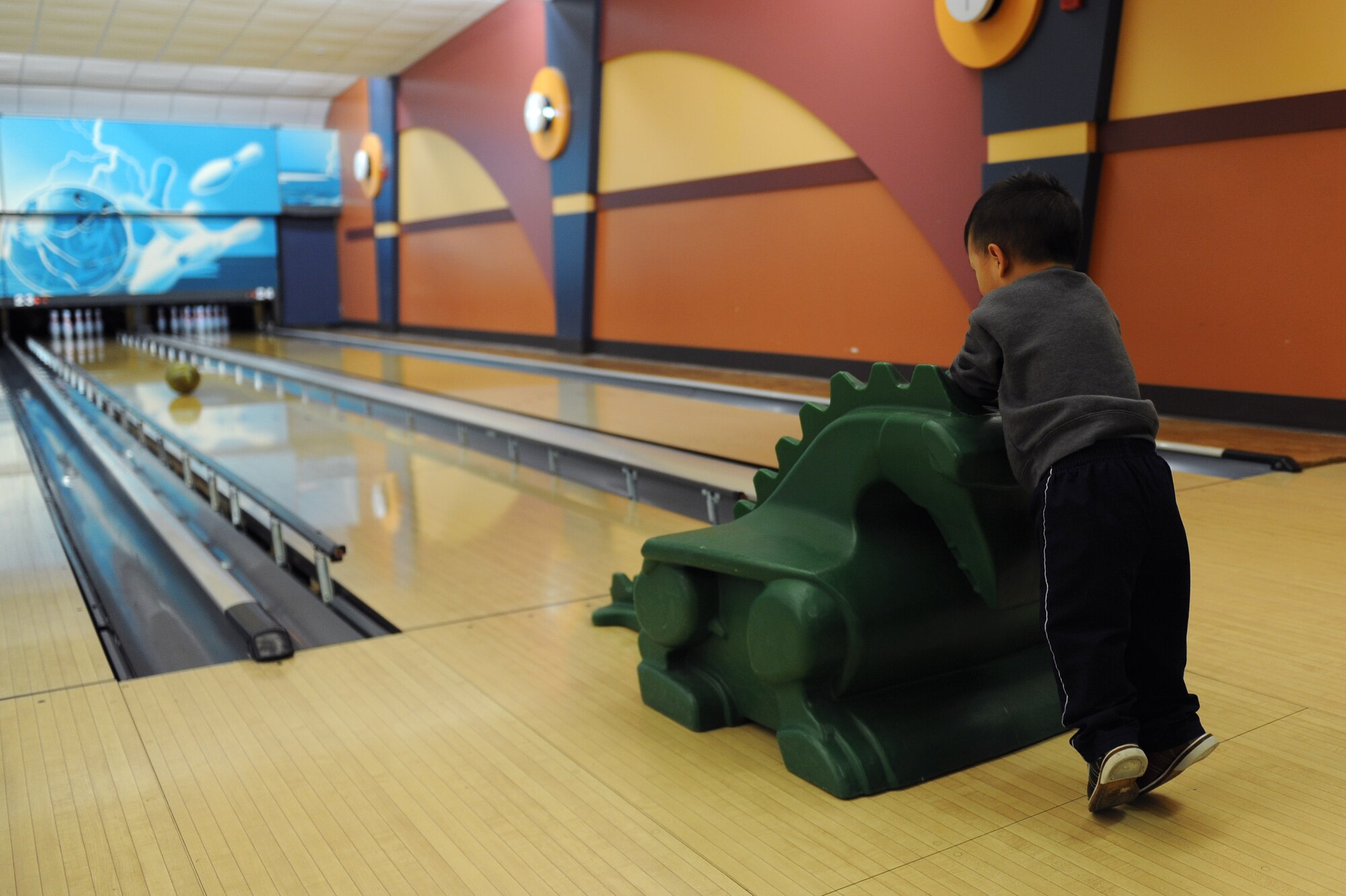 Colin Alcazar, 2 year old son of U.S. Air Force Maj. Frederick Alcazar, bowls during a “Hearts Apart” bowling event at Langley Air Force Base, Va., March 20, 2016. “Hearts Apart,” a monthly event hosted by the Airman and Family Readiness Center (A&FRC), provides families a way to connect with the A&FRC and learn about resources available to help them adapt while their family member is deployed.(U.S. Air Force photo by Senior Airman Brittany E. N. Murphy)
