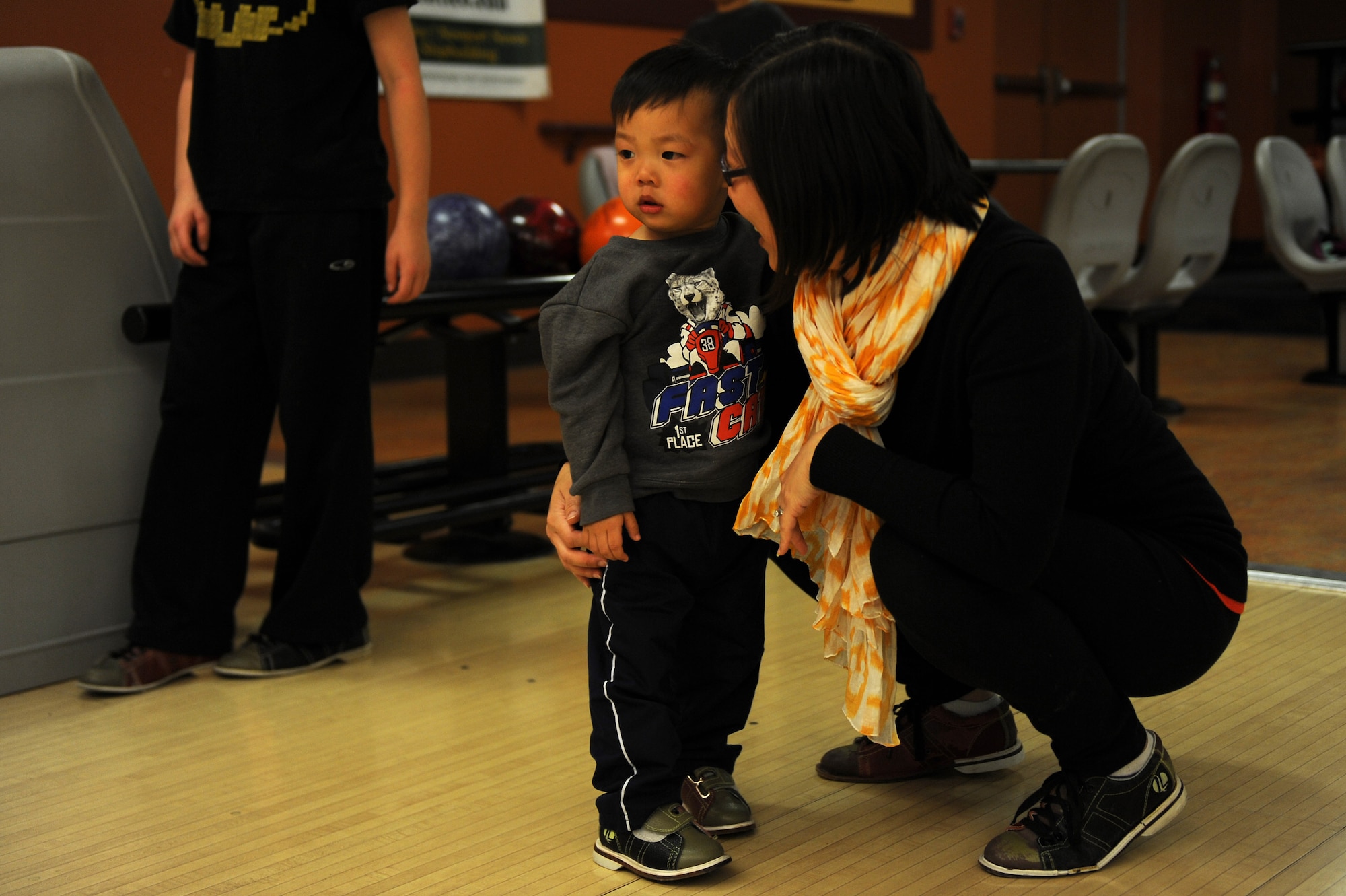 Heather Alcazar, wife of U.S. Air Force Maj. Frederick Alcazar, congratulates her son, Colin Alcazar, 2 years old, during an event hosted by the Airman and Family Readiness Center (A&FRC) at Langley Air Force Base, Va., March 20, 2016. The A&FRC provided a monthly “Hearts Apart” event for families of deployed personnel, giving them an opportunity to interact with others in similar circumstances. (U.S. Air Force photo by Senior Airman Brittany E. N. Murphy)