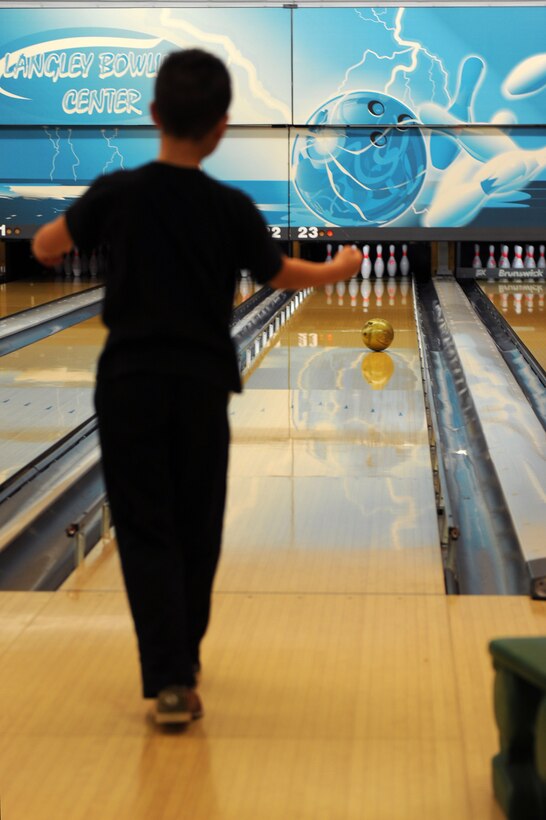 Ian Alcazar, 10 year old son of U.S. Air Force Maj. Frederick Alcazar, bowls during an Airman and Family Readiness Center (A&FRC) event at Langley Air Force Base, Va., March 20, 2016. The A&FRC hosts a monthly “Hearts Apart” event to help promote and support resilience for family members of deployed personnel .(U.S. Air Force photo by Senior Airman Brittany E. N. Murphy)