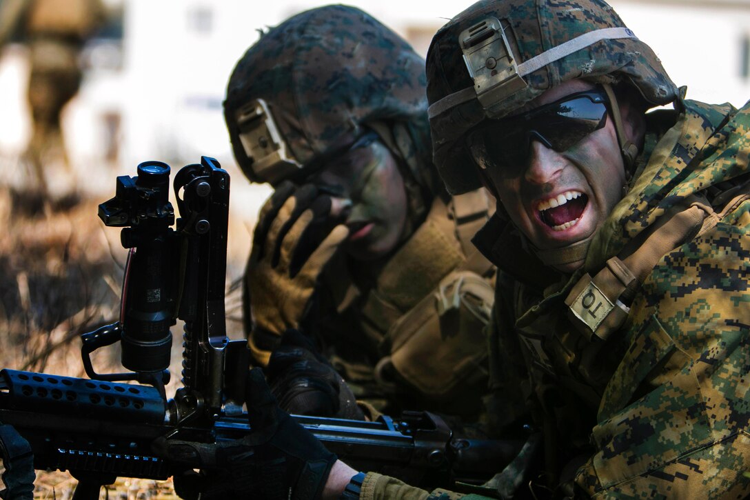 Marine Corps Lance Cpls. Cambaros Santana, right, yells out a command while providing security along with Michael Freeman during exercise Ssang Yong 16 near Pohang, South Korea, March 12, 2016. Santana is an automatic rifleman and Freeman is a team leader assigned to Echo Company, 2nd Battalion, 1st Marine Regiment. Marine Corps photo by Lance Cpl. Sean M. Evans
