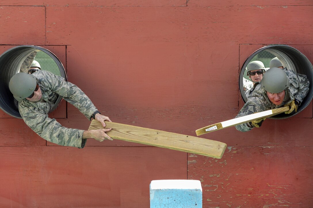 Airmen navigate an obstacle during a leadership course as part of Operational Contract Support Joint Exercise 2016 at Fort Bliss, Texas, March 22, 2016. The exercise provides training, readiness, and development of warfighter staff integration and synchronization to support the joint force commander. Air Force photo by Staff Sgt. Jonathan Snyder