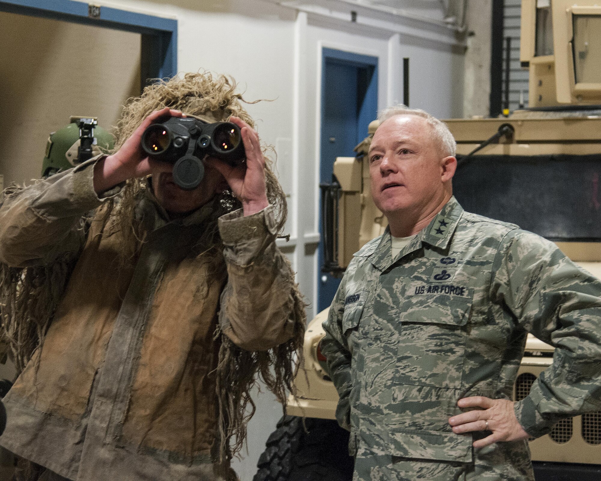 Staff Sgt. Nicholas Steiner, 790th Missile Security Forces Squadron Tactical Response Force nuclear advanced designated marksman trainer, shows Maj. Gen. Scott Jannson, Air Force Nuclear Weapons Center commander, a pair of range-finding binoculars in a TRF facility March 25, 2016, on F.E. Warren Air Force Base, Wyo. TRF Airmen use equipment such as the binoculars, battering rams and high revolutions-per-minute saws in their mission of ICBM asset protection. (U.S. Air Force photo by Senior Airman Jason  Wiese)