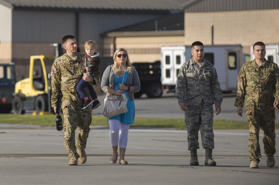 U.S. Air Force Airmen from the 71st Rescue Squadron escort loved ones on the flightline before parting ways for a deployment, March 24, 2016, at Moody Air Force Base, Ga. The 71st RQS deploys personnel to theater commanders as recovery forces for operations worldwide. (U.S. Air Force photo by Airman Daniel Snider/Released)