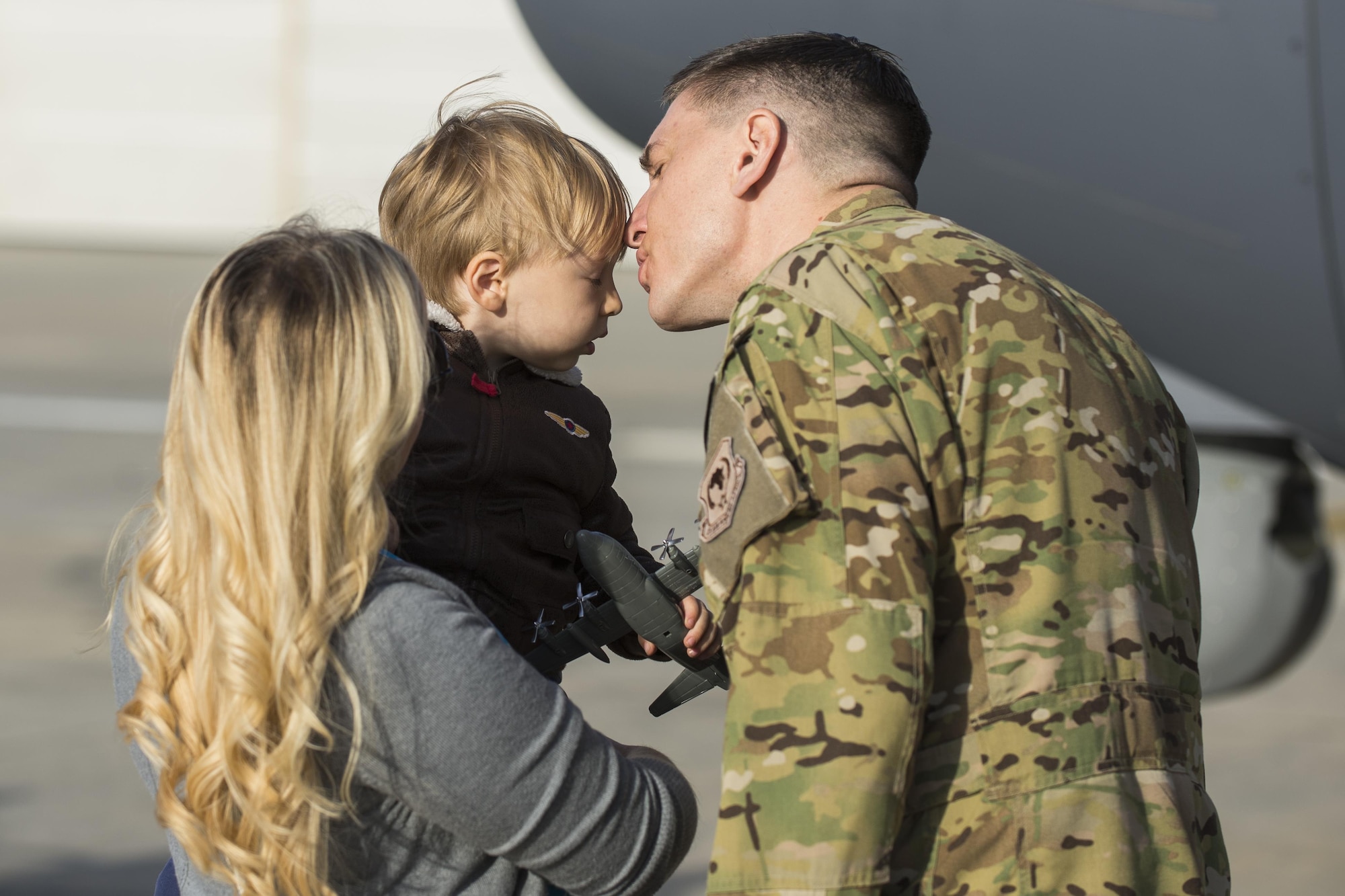 U.S. Air Force Capt. Luke Sandbeck, 71st Rescue Squadron HC-130J Combat King II pilot, kisses his son, Dom, before departing on his deployment, March 24, 2016, at Moody Air Force Base, Ga. The basic crew for an HC-130J includes five Airmen: a pilot, co-pilot, a combat systems officer and two loadmasters. (U.S. Air Force photo by Airman Daniel Snider/Released)