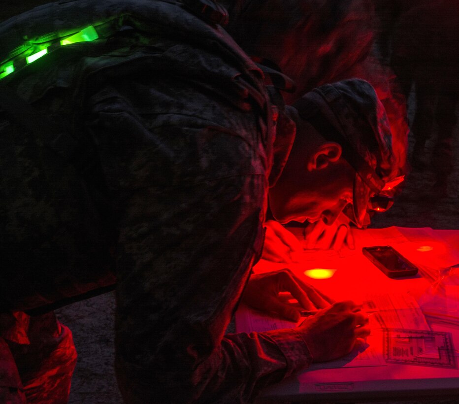 A soldier plots points on a map before participating in the night land navigation course part of the 2016 Best Warrior competition at Fort Jackson, S.C., March 21, 2016. Army photo by Sgt. 1st Class Brian Hamilton