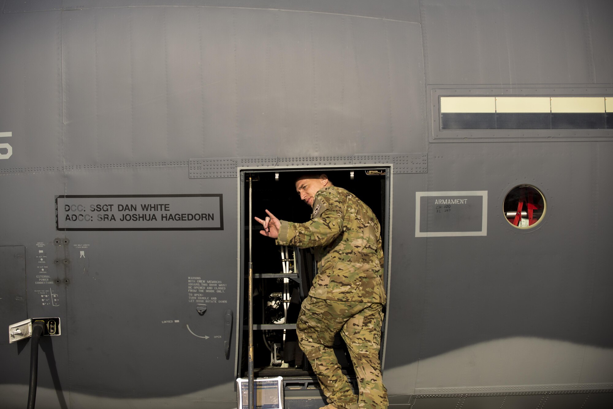 U.S. Air Force Capt. Luke Sandbeck, 71st Rescue Squadron HC-130J Combat King II pilot, signs ‘I love you’ in American Sign Language  to his family as he enters an HC-130J, March 24, 2016, at Moody Air Force Base, Ga. Airmen from the 71st RQS are trained to support the rescue of isolated personnel from harsh or inaccessible locations. (U.S. Air Force photo by Airman Daniel Snider/Released)