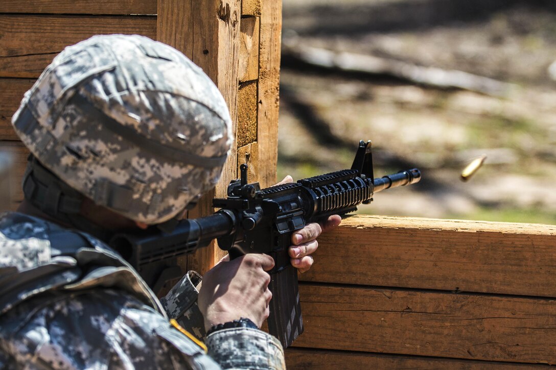 A soldier fires his weapon through an open window at targets at the buddy team live-fire range during the 2016 Best Warrior competition at Fort Jackson, S.C., March 23, 2016. Army photo by Sgt. 1st Class Brian Hamilton