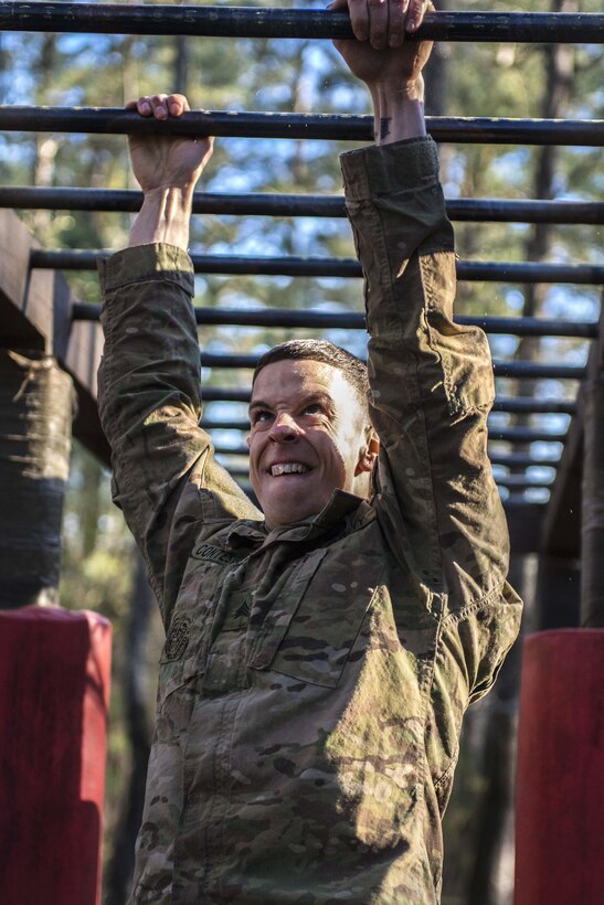 Army Sgt. Nicholas Constable navigates monkey bars at the endurance obstacle course during the 2016 Best Warrior competition at Fort Jackson, S.C., March 23, 2016. Constable is assigned to the 2nd Brigade, 98th Training Division. Army photo by Sgt. 1st Class Brian Hamilton