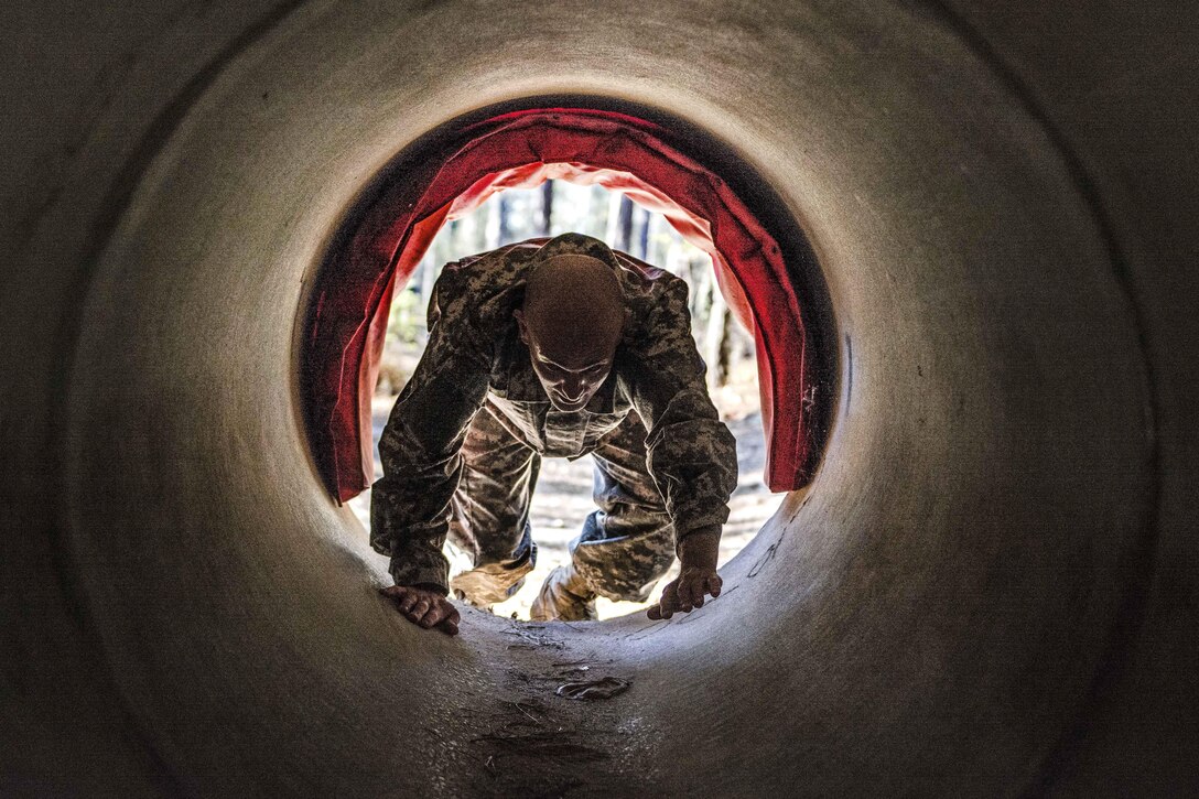 Army Sgt. 1st Class Ethan Feldner crawls through a culvert during the endurance obstacle course as part of the 2016 Best Warrior competition at Fort Jackson, S.C., March 23, 2016. Feldner is assigned to the 95th Training Division. Army photo by Sgt. 1st Class Brian Hamilton