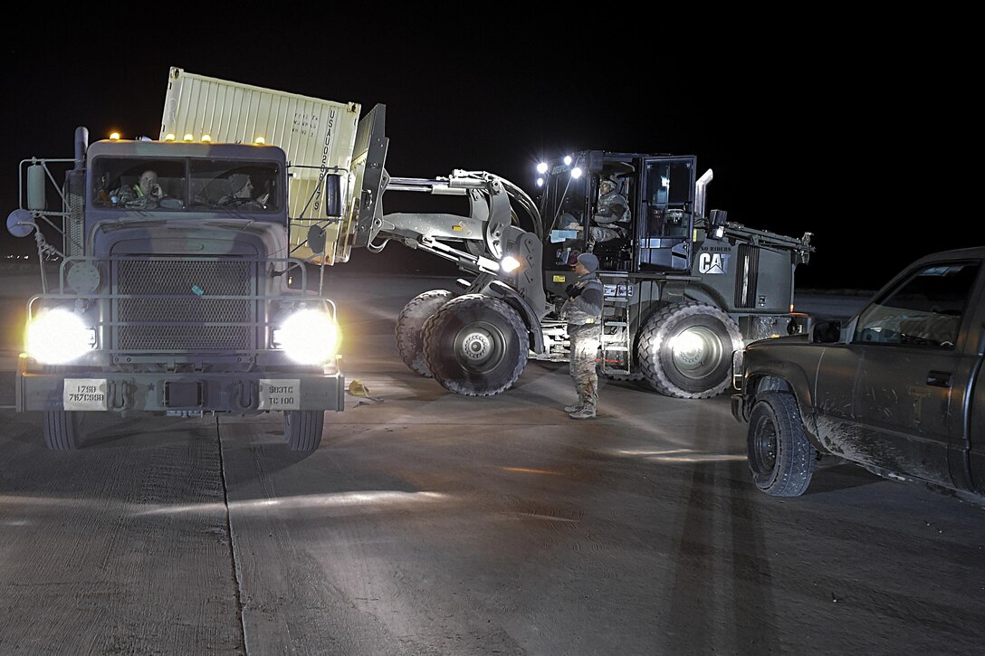 Airmen load cargo to the back of a truck during Exercise Turbo Distribution 16-02 at Amedee Army Airfield, Calif., March 15, 2016. Air Force photo by Staff Sgt. Robert Hicks
