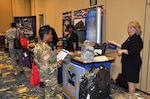 DLA Troop Support representative Sally Pooler (right) answers questions from a soldier at the Warfighter Support Initiative, Fort Bragg, North Carolina, March 23, 2016.