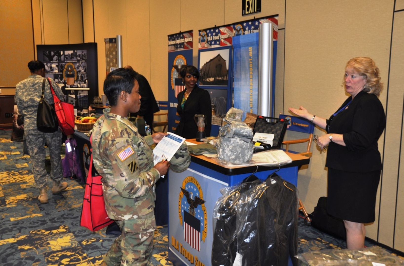 DLA Troop Support representative Sally Pooler (right) answers questions from a soldier at the Warfighter Support Initiative, Fort Bragg, North Carolina, March 23, 2016.