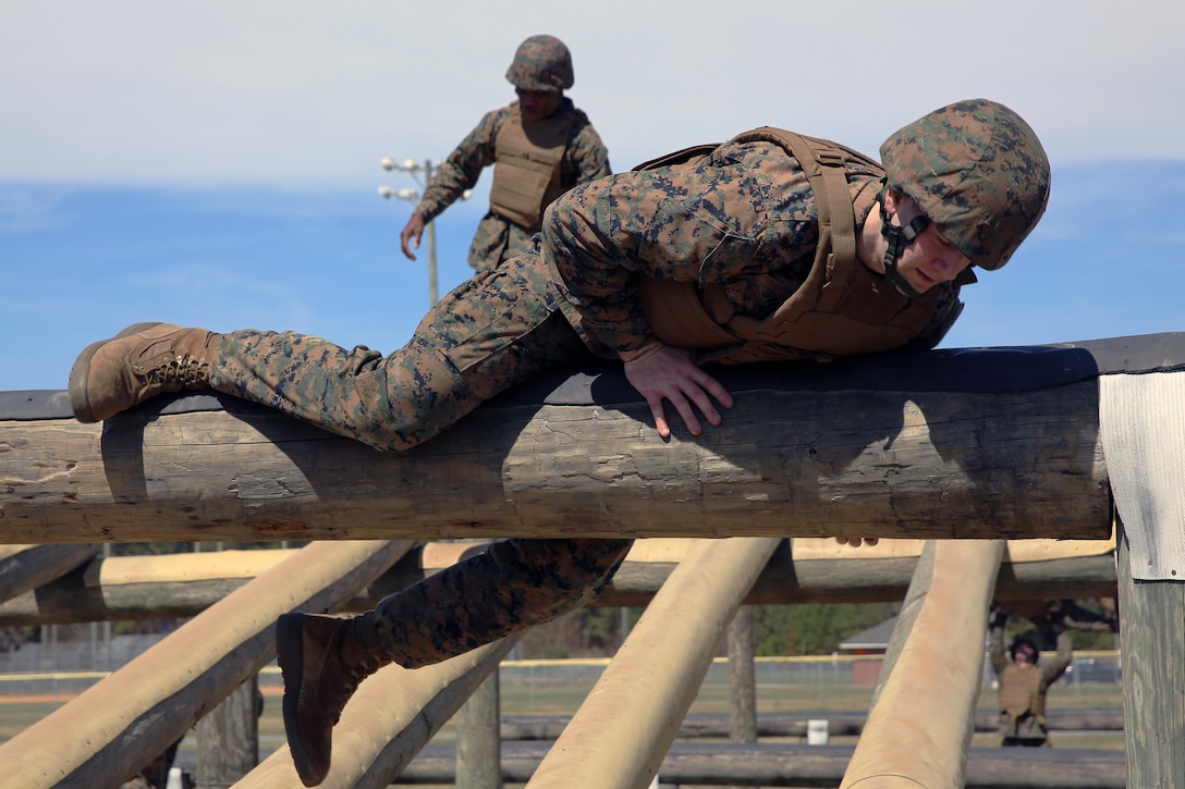 Cpl. Thomas Sterk negotiates an obstacle while completing the obstacle course during a team building exercise at Marine Corps Air Station Cherry Point, N.C., March 18, 2016. The obstacle course is utilized as a confidence builder for Marines as it challenges their physical and mental strength while encouraging leadership skills. Sterk is a food service specialist with Headquarters and Headquarters Squadron. (U.S. Marine Corps photo by Lance Cpl. Mackenzie Gibson/Released)

