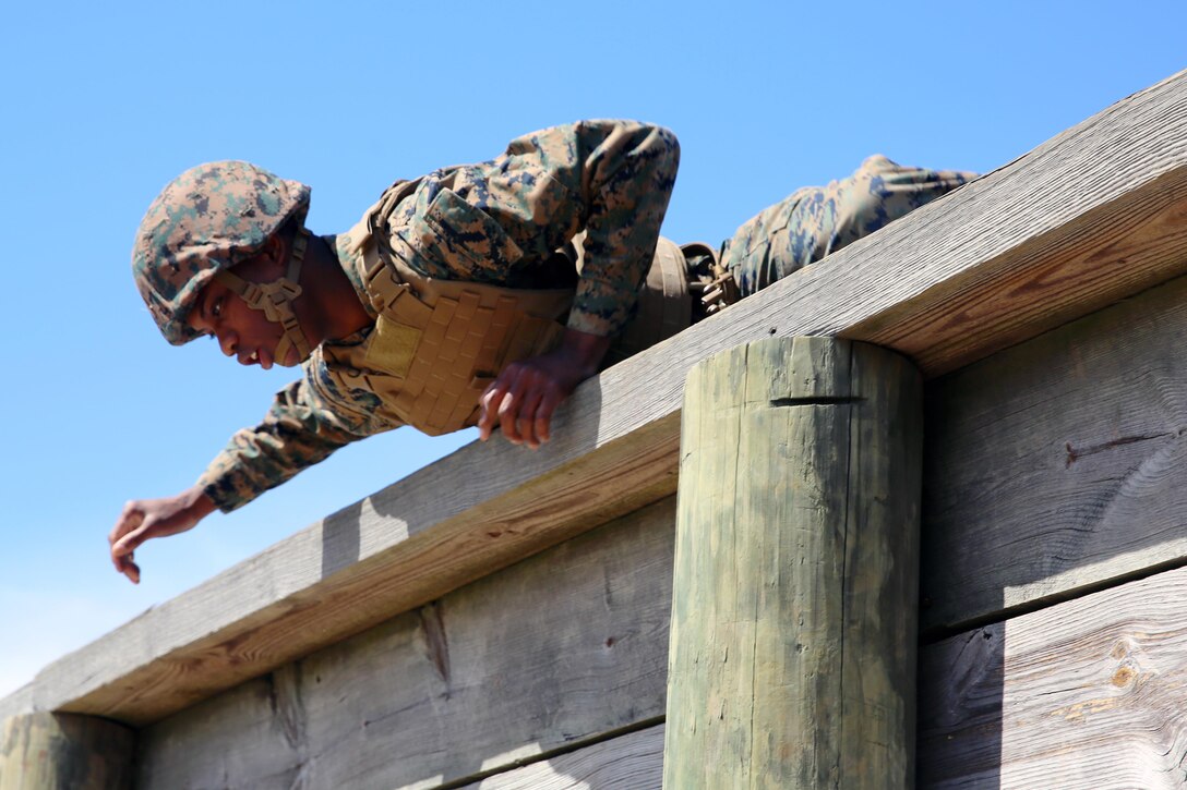 Cpl. Jaylen M. Thomas negotiates an obstacle while completing the obstacle course during a team building exercise at Marine Corps Air Station Cherry Point, N.C., March 18, 2016. The obstacle course is utilized as a confidence builder for Marines as it challenges their physical and mental strength while encouraging leadership skills. Thomas is a food service specialist with Headquarters and Headquarters Squadron. (U.S. Marine Corps photo by Lance Cpl. Mackenzie Gibson/Released)
