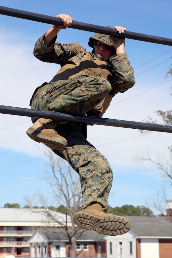 Sgt. Scott Maynard negotiates an obstacle while completing the obstacle course during a team building exercise at Marine Corps Air Station Cherry Point, N.C., March 18, 2016. The obstacle course is utilized as a confidence builder for Marines as it challenges their physical and mental strength while encouraging leadership skills. Maynard is a food service specialist with Headquarters and Headquarters Squadron. (U.S. Marine Corps photo by Lance Cpl. Mackenzie Gibson/Released)