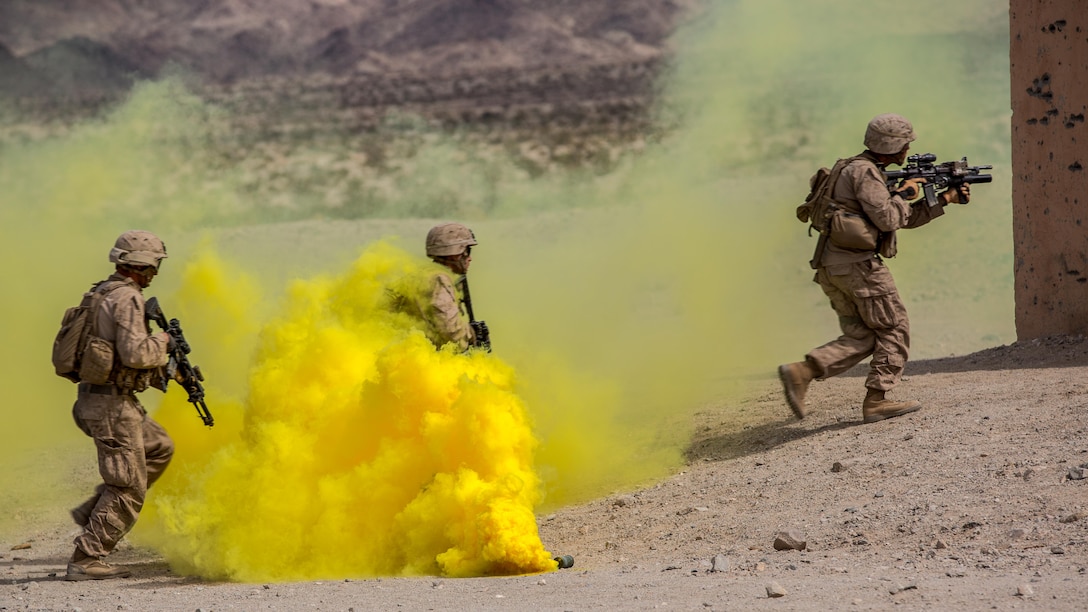Marines with Company B, 3rd Light Armored Reconnaissance Battalion, run through smoke during a live-fire assault on Military Operations on Urban Terrain town located at Range 210 in the Combat Center training area March 24, 2016, as part of a Marine Corps Combat Readiness Evaluation Exercise. 3rd LAR conducted a five-day MCCREE to evaluate the combat readiness of B Co.