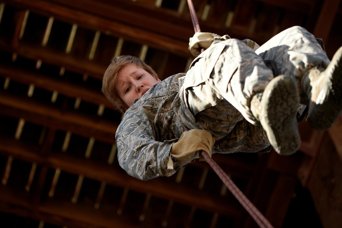 An airman rappels down from a tower during Operational Contract Support Joint Exercise 2016 at Fort Bliss, Texas, March 22, 2016. Air Force photo by Staff Sgt. Jonathan Snyder