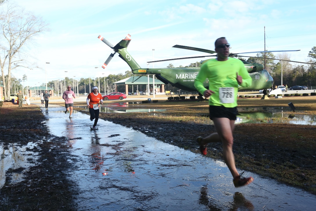 Participants race past the aviation memorial on Marine Corps Air Station New River during the Xtreme Endurance Challenge 12k+ held on Feb. 6. The X-treme Endurance Challenge 12k+ is part of Marine Corps Community Services Semper Fit Grand Prix races.  (U.S. Marine Corps photo by Cpl. Mark Watola /released)