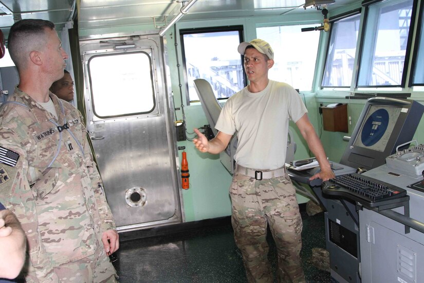 Kuwait Naval Base - Staff Sgt. Harcel Rosado, assigned to the 97th Transportation Company out of Joint Base Langley/Eustis explains the functions of the Landing Craft Utility boat to members of 1st TSC during exercise Nautical Horizon. Rosado is the boat crew’s boatswain, responsible for planning and assigning the daily work schedule to the deck crew and maintains order and cleanliness. (U.S. Army photo by Master Sgt. Dave Thompson, released)