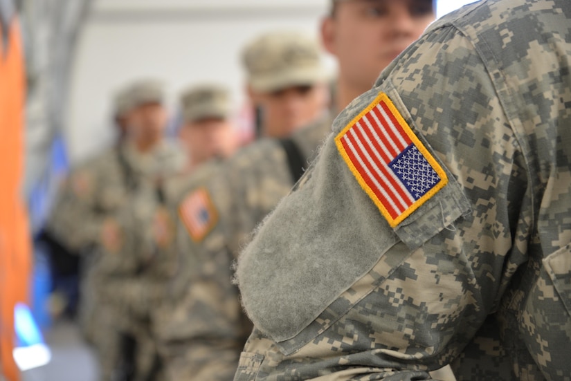 Soldiers stand in formation during a deployment ceremony for the 392nd Expeditionary Signal Battalion, which will be heading overseas in support of Operation Enduring Freedom – Spartan Shield. More than 500 family members and friends attended the ceremony on Saturday, March 26, 2016 on Fort Meade, Md.