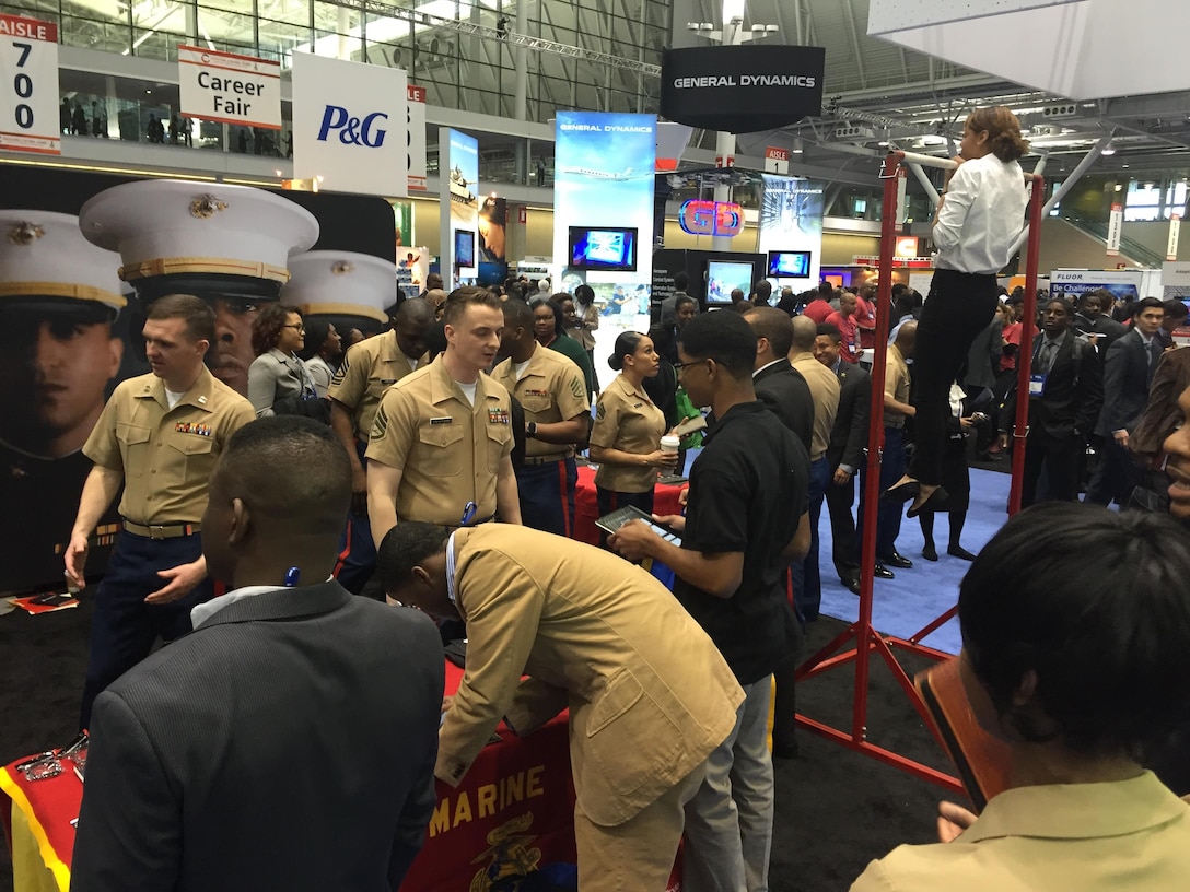 BOSTON, Massachusetts - Marines of Recruiting Station Portsmouth, New Hampshire, engage attendees of the National Society of Black Engineers convention about careers and opportunities in the Marine Corps at the Boston Convention Center, March 24. NSBE is a student-run organization focused on the employment of minority engineers from across the country. The Marines set up in the career fair part of the convention as well as aiding in resume creating and running morning workout sessions with interested students. (Official U.S. Marine Corps photo by Sgt. Jonathan G. Wright)