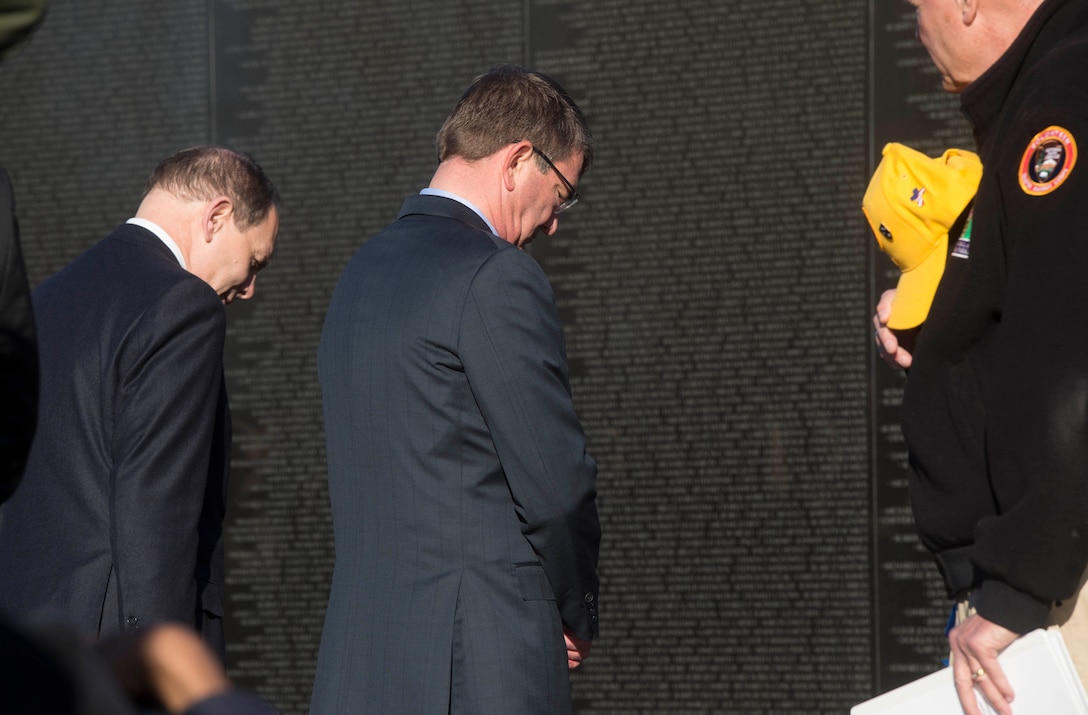 Defense  Secretary Ash Carter, right, and Veterans Affairs Secretary Bob McDonald observe a moment of silence after laying a wreath at the Vietnam Veterans Memorial in Washington, D.C., March 29, 2016. DoD photo by Navy Petty Officer 1st Class Tim D. Godbee