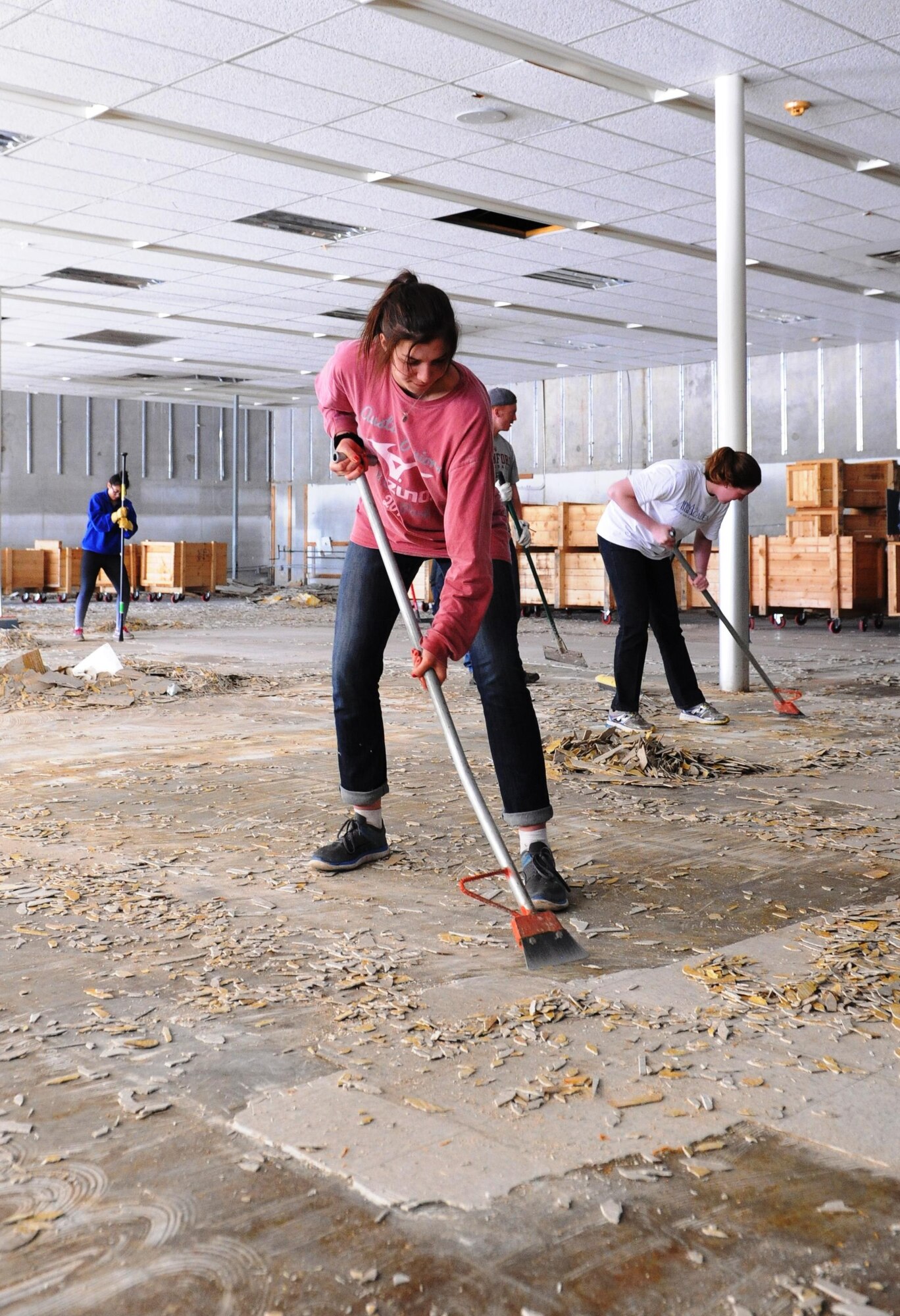 Cadet 4th Class Abigail Miksch scrapes tile from an old storefront March 24, 2016 in Houston. The store is being refurbished to become a receiving area for donations to Habitat for Humanity. Miksch was one of 15 U.S. Air Force Academy cadets in Houston and 75 cadets giving up their Spring Break to do construction work with Habitat for Humanity in Houston; Sacramento, Calif.; Oklahoma City; Corpus Christi, Texas; Des Moines, Iowa; and Tupelo, Miss., March 21-25.  (U.S. Air Force photo/ John Van Winkle)
