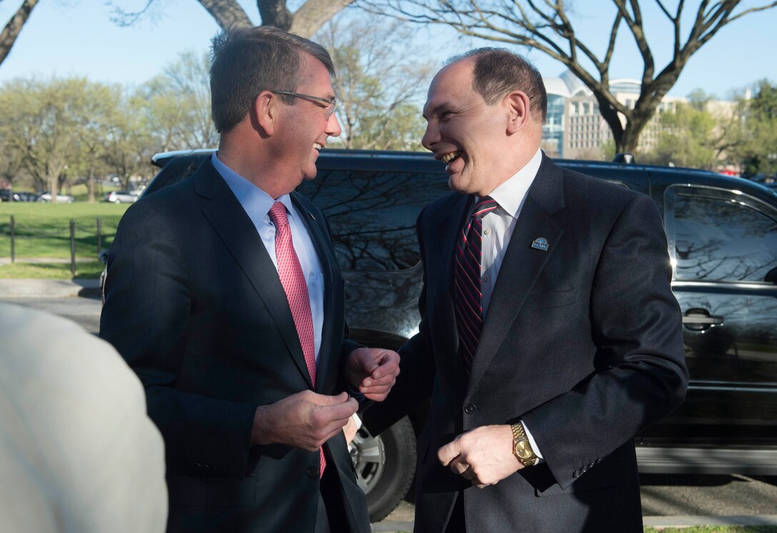 Defense Secretary Ash Carter, left, and Veterans Affairs Secretary Bob McDonald share a moment at the Vietnam Veterans Memorial in Washington, D.C., March 29, 2016. DoD photo by Navy Petty Officer 1st Class Tim D. Godbee