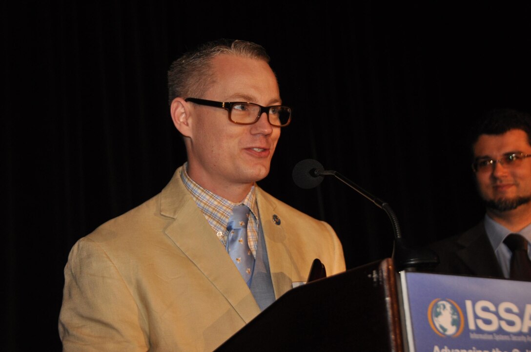 Chief Warrant Officer 3 David Vaughn accepts the Information Systems Security Association's (ISSA) Annual Volunteer Award in Raleigh, North Carolina, October 13, 2015. Vaughn is assigned to the U.S. Army Reserve Cyber Operation Group and volunteers a large amount of his free time to civilian and military cyber and information technology based organizations. He was serving as the Director of Education for the Raleigh North Carolina Chapter of ISSA when he received this award. (Photo courtesy of ISSA)