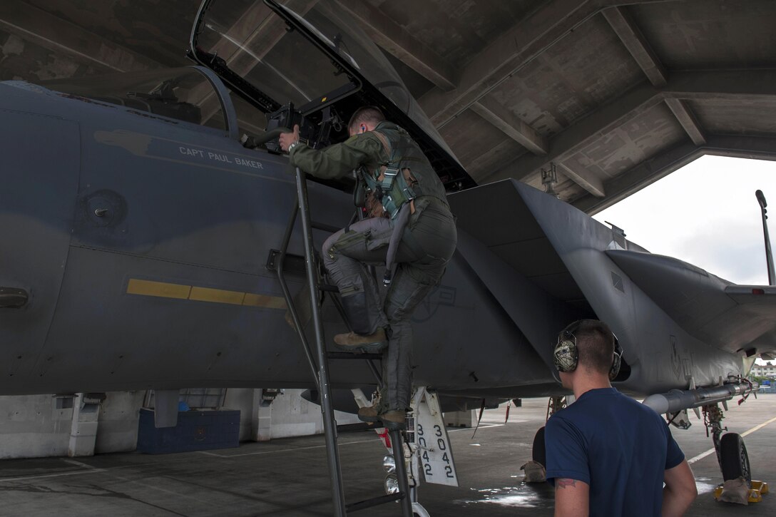 Navy Lt. Dustin Henze climbs into an F-15 Eagle aircraft during a no-notice exercise at Kadena Air Base, Japan, March 18, 2016. Henze is a Navy exchange pilot assigned to the 44th Fighter Squadron. Air Force photo by Airman 1st Class Lynette M. Rolen