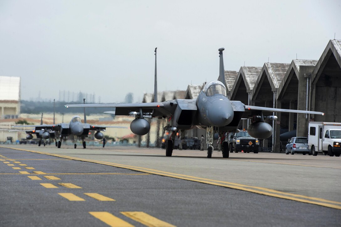 Three F-15 Eagle aircraft taxi down the runway during a no-notice exercise at Kadena Air Base, Japan, March 18, 2016. Air Force photo by Airman 1st Class Lynette M. Rolen