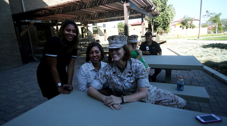 Chief Petty Officer Jaclyn Place poses for a photo with her neighbors during Place’s award ceremony aboard Camp Pendleton, Calif., March 11, 2016. Place is a lead chief petty officer with the Headquarters Regimental Aid Station, 1st Marine Logistics Group, and was awarded an impact Navy and Marine Corps Commendation Medal for her selfless and decisive actions that saved the lives of her neighbors. (U.S. Marine Corps photo by Sgt. Laura Gauna/released)