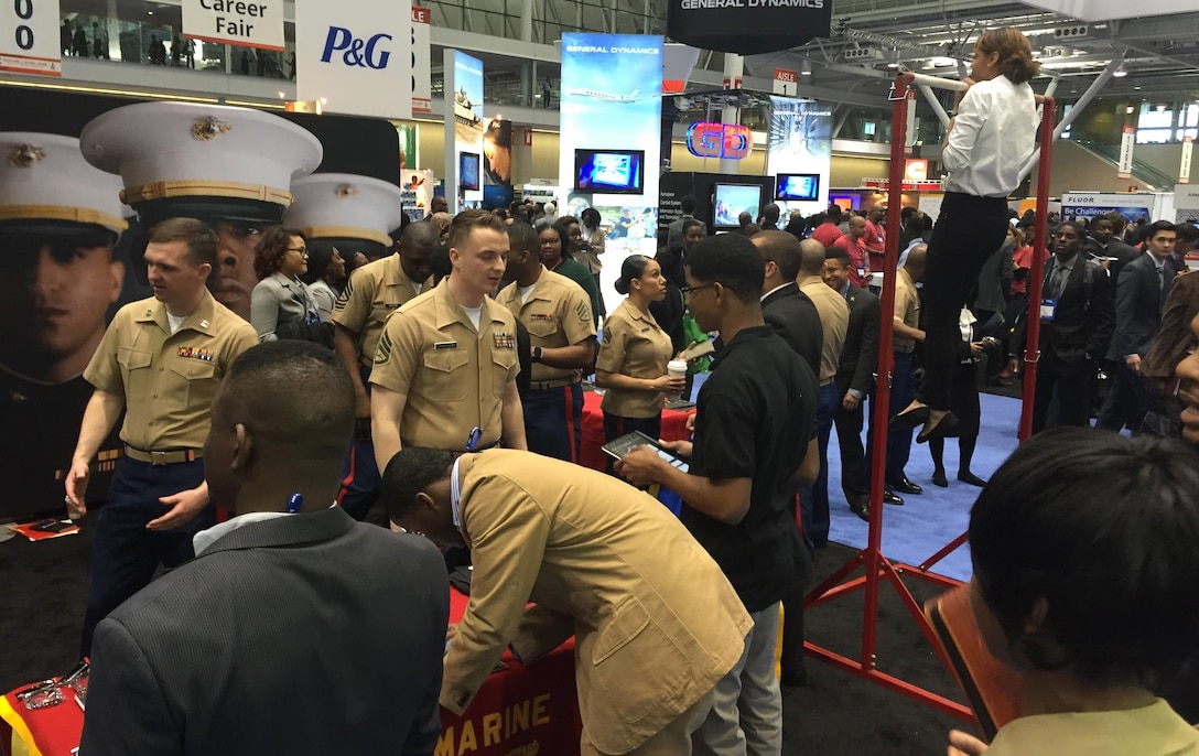 BOSTON - Marines of Recruiting Station Portsmouth, New Hampshire, engage attendees of the National Society of Black Engineers convention about careers and opportunities in the Marine Corps at the Boston Convention Center, March 24. NSBE is a student-run organization focused on the employment of minority engineers from across the country. The Marines set up in the career fair part of the convention as well as aiding in resume creating and running morning workout sessions with interested students. (Official U.S. Marine Corps photo by Sgt. Jonathan G. Wright)