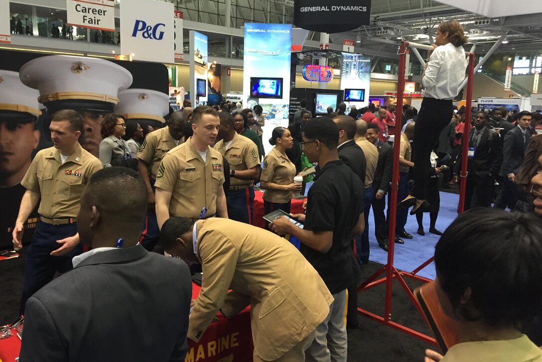 BOSTON, Massachusetts - BOSTON, Massachusetts - Marines of Recruiting Station Portsmouth, New Hampshire, engage attendees of the National Society of Black Engineers convention about careers and opportunities in the Marine Corps at the Boston Convention Center, March 24. NSBE is a student-run organization focused on the employment of minority engineers from across the country. The Marines set up in the career fair part of the convention as well as aiding in resume creating and running morning workout sessions with interested students. (Official U.S. Marine Corps photo by Sgt. Jonathan G. Wright) 
