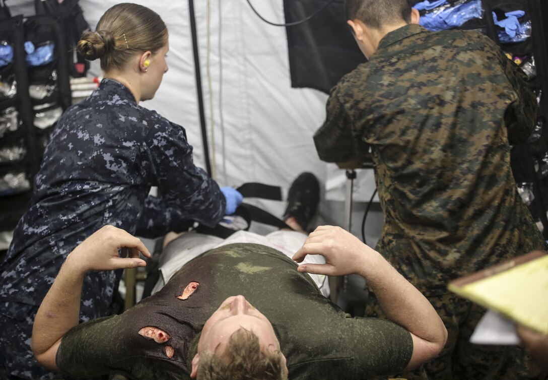 U.S. Navy Ensign Julia Mauer, a nurse with 2nd Medical Battalion, tends to a simulated casualty during a mass casualty training scenario at Camp Lejeune, N.C., March 25, 2016. The training was held to evaluate medical personnel capabilities in a field environment with limited manpower and resources. (U.S. Marine Corps photo by Cpl. Paul S. Martinez/Released)