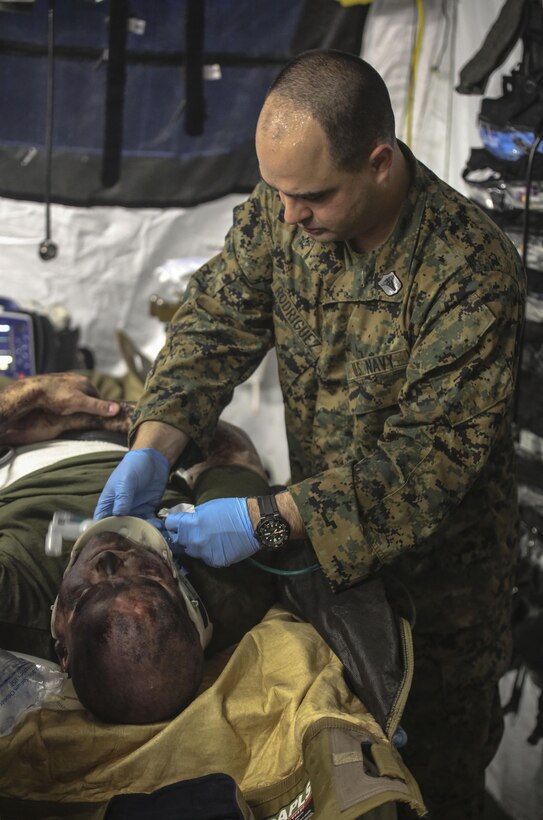 U.S. Navy Petty Officer 3rd Class Andres Rodriguez, a hospital corpsman with 2nd Medical Battalion, tends to a simulated casualty during a mass casualty training scenario at Camp Lejeune, N.C., March 25, 2016. The training was held to evaluate medical personnel capabilities in a field environment with limited manpower and resources. (U.S. Marine Corps photo by Cpl. Paul S. Martinez/Released)