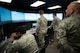 Chief Master Sgt. Jose Barraza (right), 12th Air Force (Air Forces Southern) command chief, watches young air traffic controllers operate a simulator at Mountain Home Air Force Base, Idaho, March 23, 2016. Barraza expressed how impressed he was with Airman 1st Class Wayne Harper, 366th Operations Support Squadron air traffic control apprentice, saying Harper's professionalism was well beyond what he normally sees in an airman first class. Barraza presented Harper with a coin at the end of the demonstration. (U.S. Air Force photo by Tech. Sgt. Samuel Morse/RELEASED)