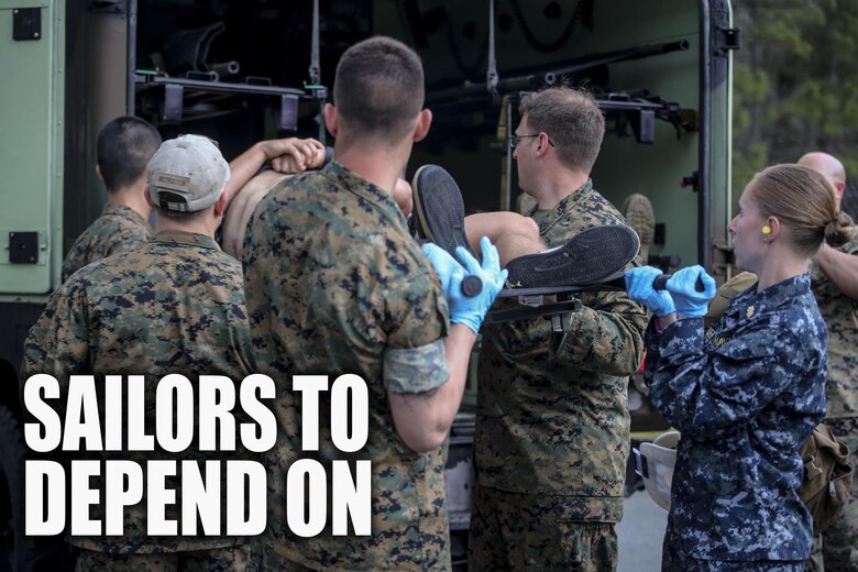 Sailors with 2nd Medical Battalion load a simulated casualty into a medical humvee during a mass casualty training scenario at Camp Lejeune, N.C., March 25, 2016. The simulated injuries the sailors encountered included gunshot wounds, blast wounds and burns. (U.S. Marine Corps photo illustration by Cpl. Paul S. Martinez/Released)