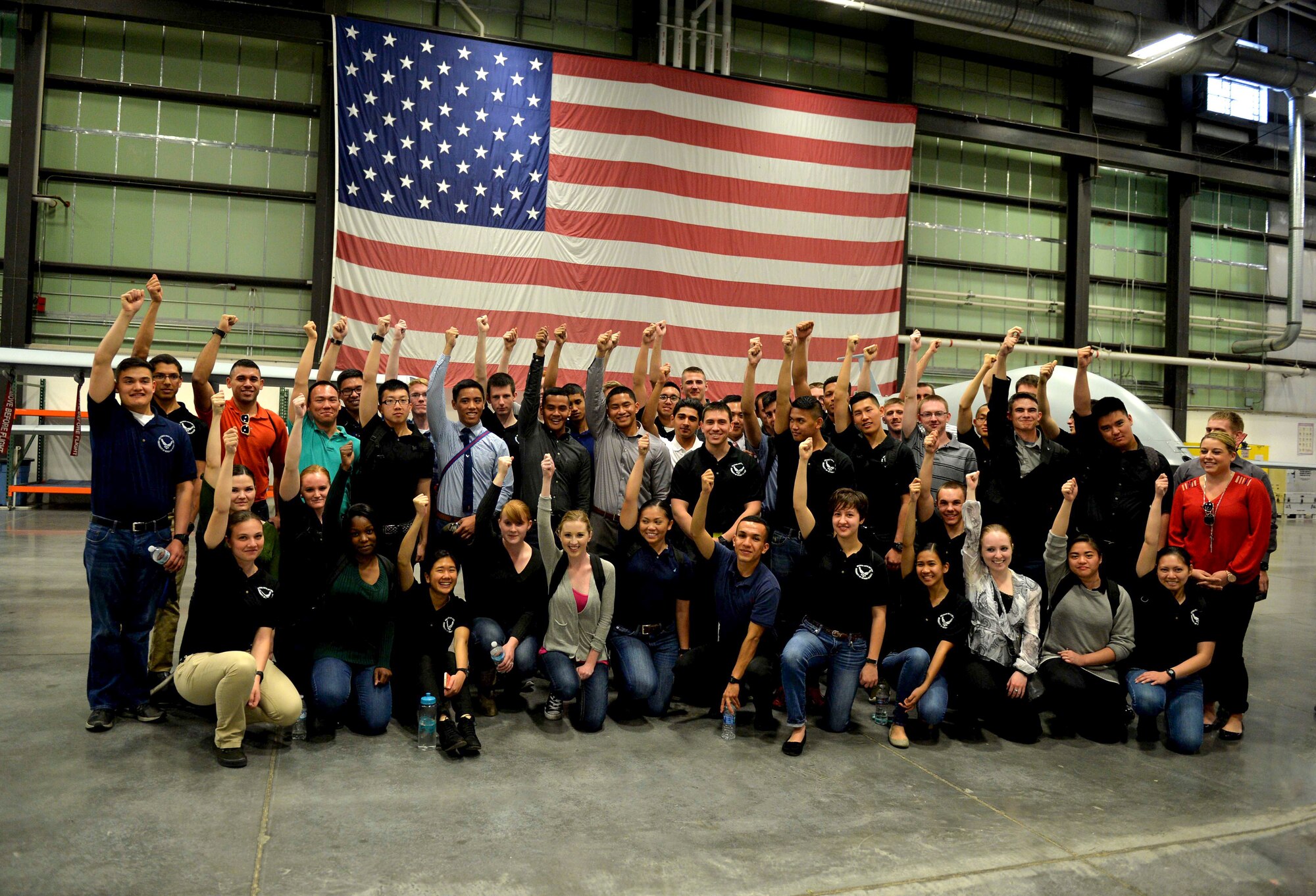 Cadets from the Reserve Officer Training Corps Detachment 004, Las Vegas, pose for a photo in the 11th Reconnaissance Squadron hangar March 11, 2016, at Creech Air Force, Nevada. The cadets were able to see remotely piloted aircraft up close, and ask questions about the aircraft. The briefing included video feed taken of the MQ-1 Predator and MQ-9 Reaper in action, and provided additional information for the soon-to-be officers to consider when choosing a career field. (U.S. Air Force photo by Airman 1st Class Kristan Campbell/Released)