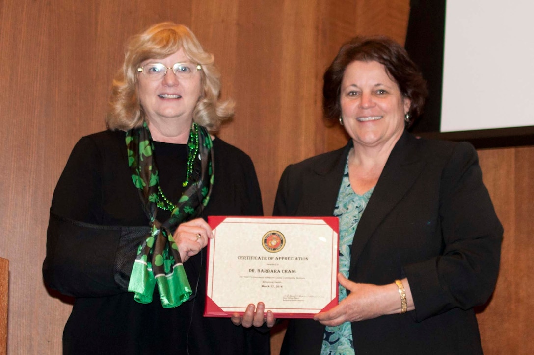 Barbara Craig, counselor with Armed Forces Center for Child Protection, left, receives a certificate for her participation in the Building Bridges behavior health speaker’s series March 17 at the Gray Research Center. The one-day conference combined military and community leaders in the behavior health community.